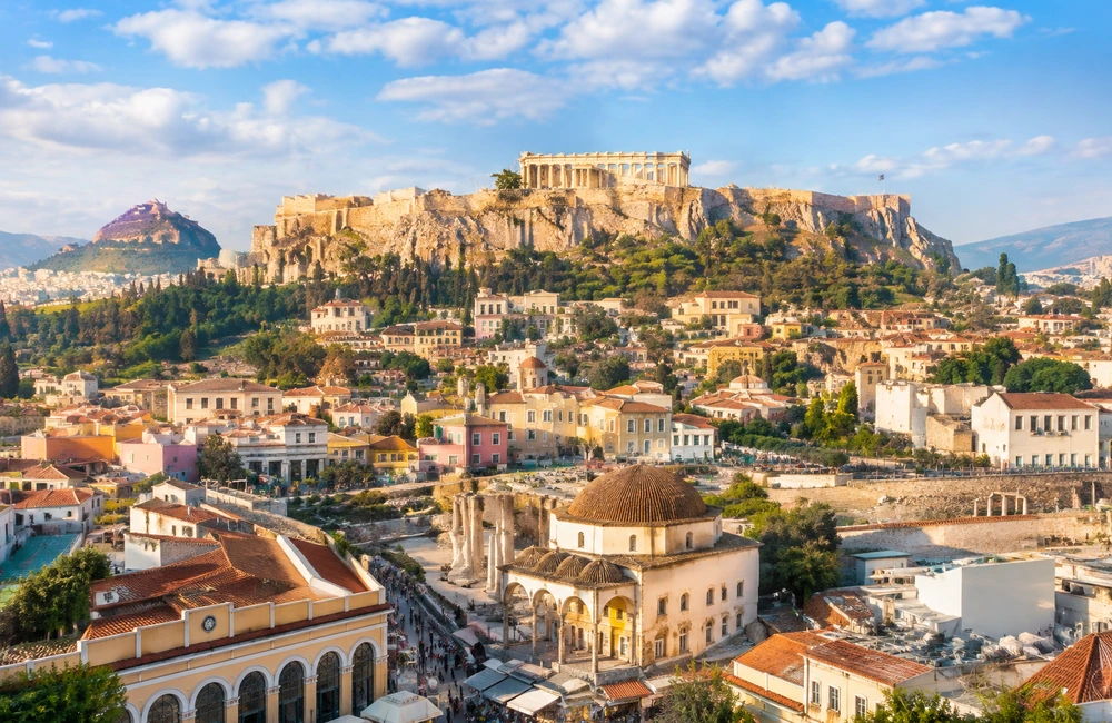 Panoramic view of Athens, Greece, with the Acropolis and Parthenon overlooking the historic city.