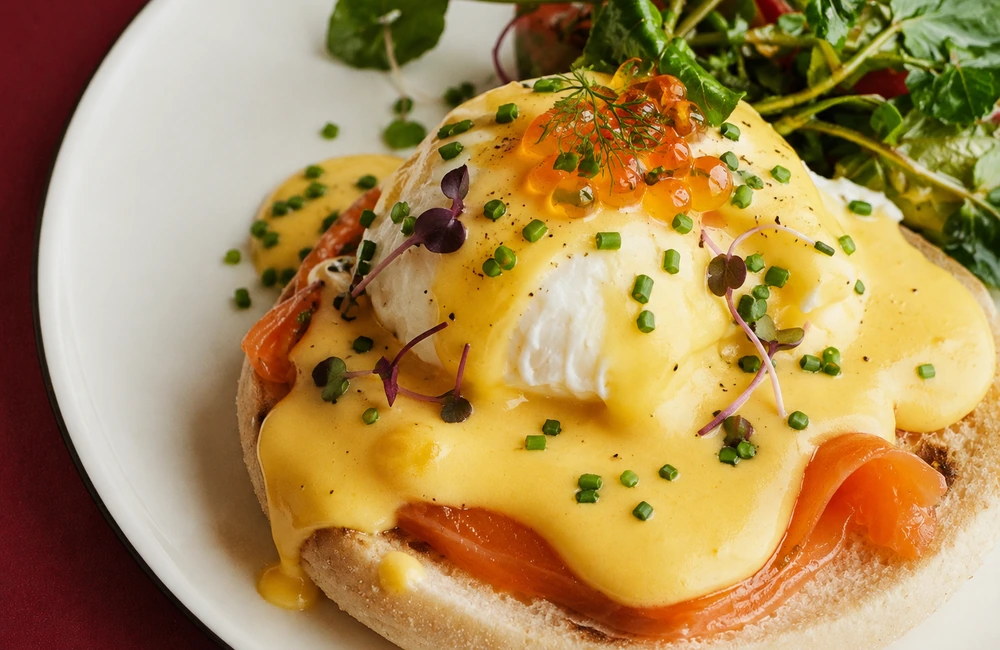 Eggs Benedict with smoked salmon, poached egg, hollandaise sauce, fresh chives, microgreens and salmon roe at Canary Riverside Plaza Hotel, London.