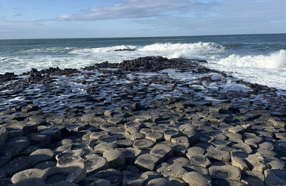 Giant's Causeway on the Antrim Coast of Northern Ireland, with its famous basalt columns meeting the Atlantic Ocean.