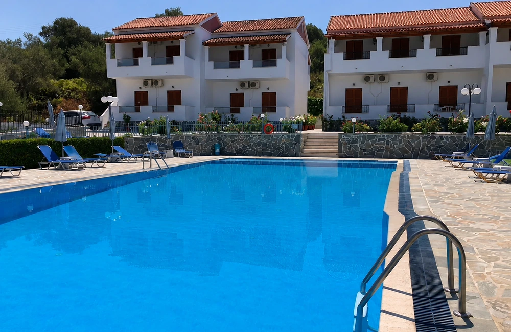 Swimming pool and apartments at Tria Adelphia in Arillas Corfu